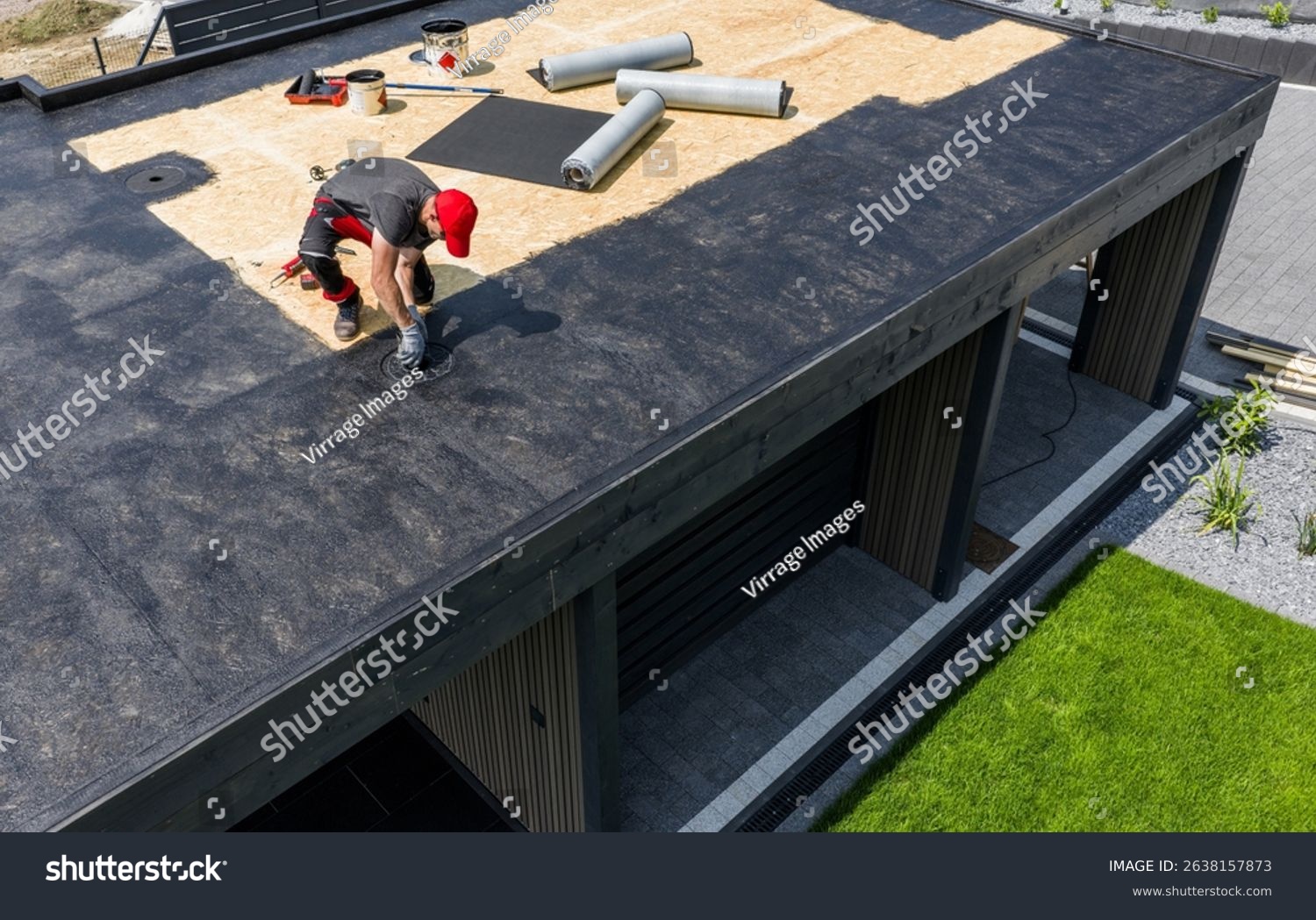 stock-photo-a-construction-worker-is-installing-epdm-roofing-material-on-a-contemporary-home-under-clear-skies-2638157873