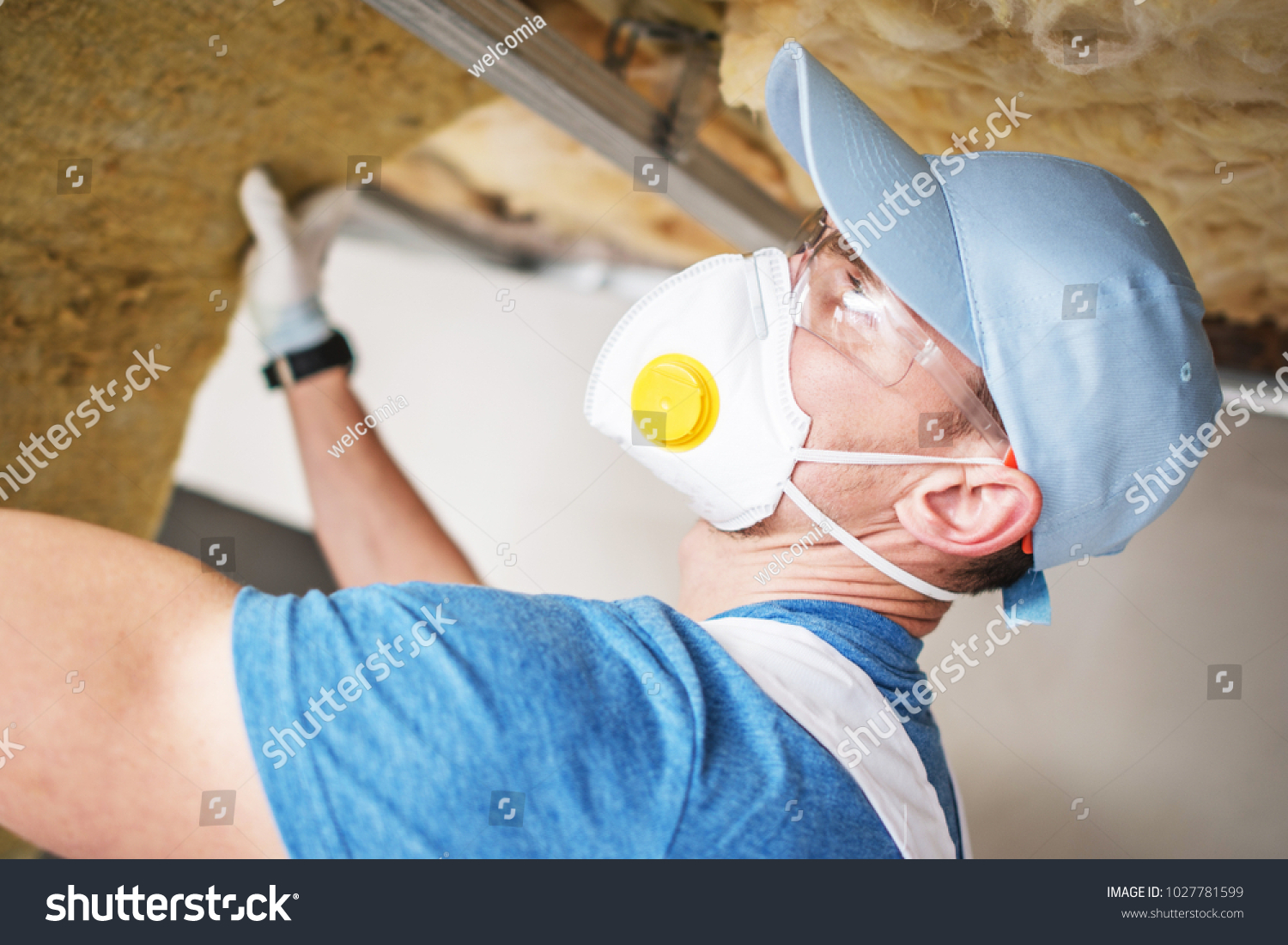 stock-photo-insulating-material-installation-by-caucasian-contractor-worker-building-insulation-1027781599