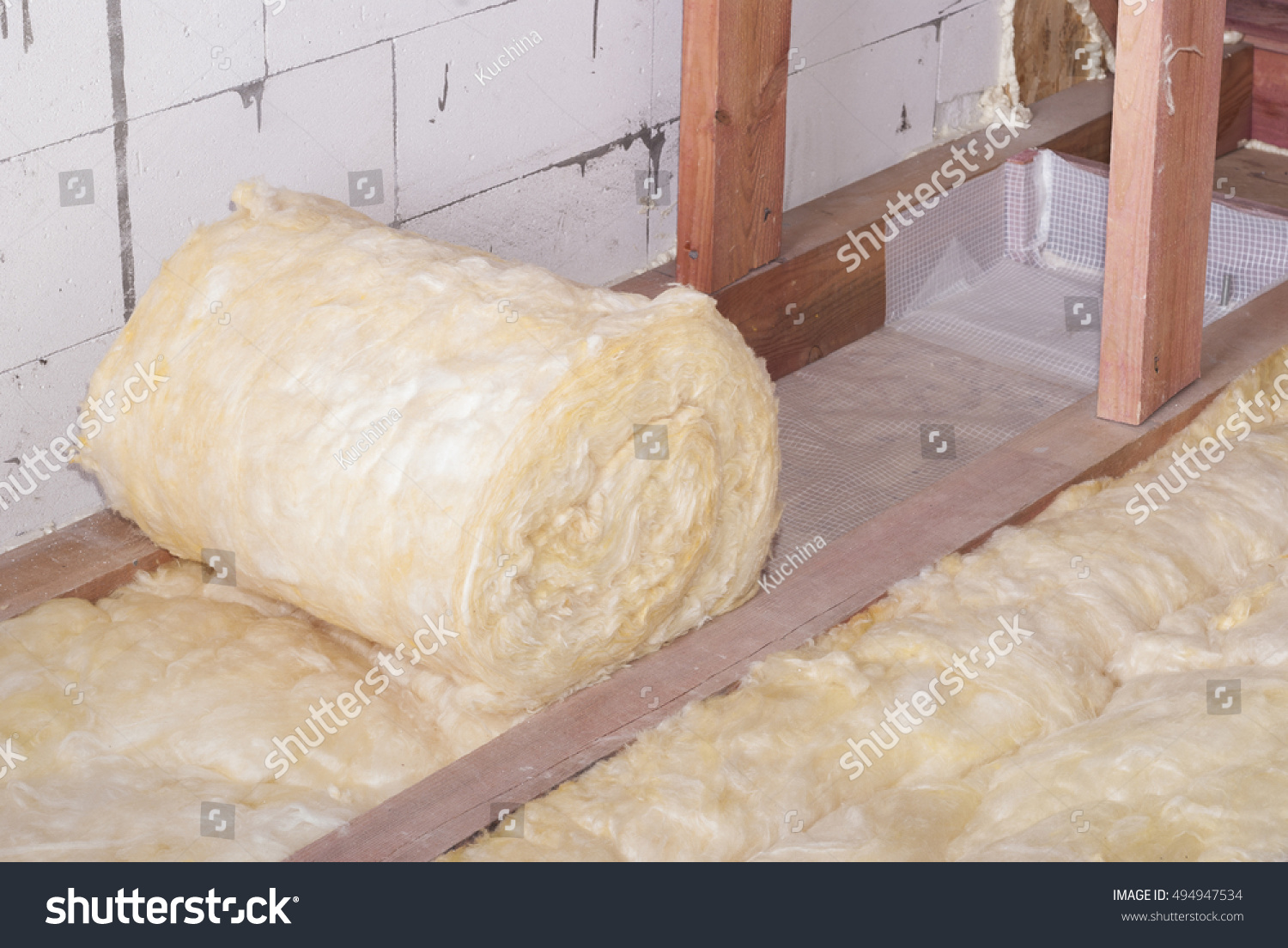 stock-photo-roll-of-mineral-wool-insulation-in-the-attic-floor-494947534