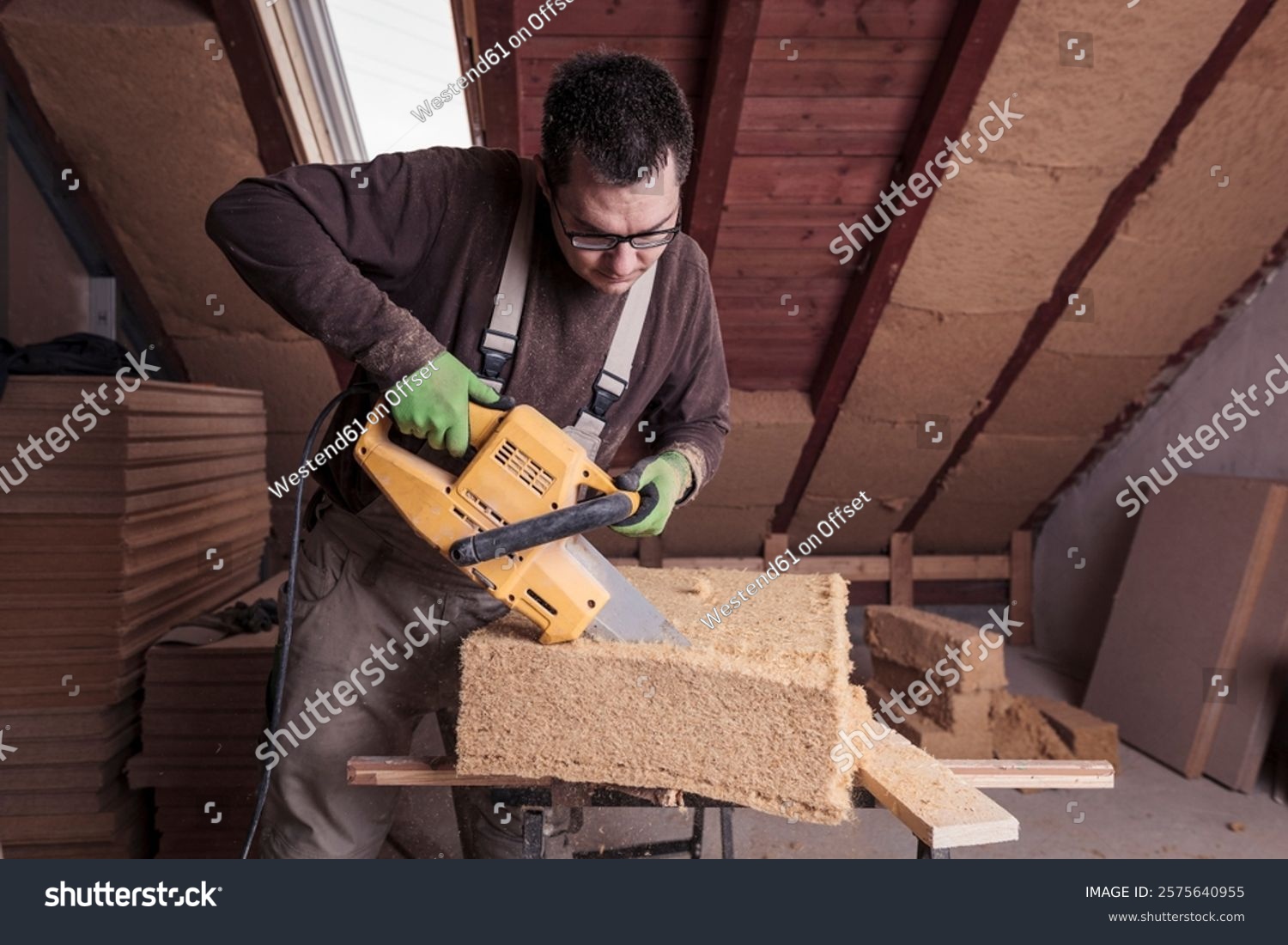 stock-photo-roof-insulation-worker-cutting-wood-fibre-insulation-2575640955